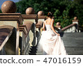 fashion photo of beautiful woman in wedding dress posing outdoor. 47016159