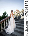 fashion photo of beautiful woman in wedding dress posing outdoor. 47016171