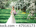 Portrait of young woman in the flowered garden in the spring time. 47016173