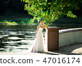 fashion photo of beautiful woman in wedding dress posing outdoor. 47016174