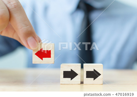Businessman hand picked wooden block red arrow Businessman hand picked wooden block red arrow 47016919