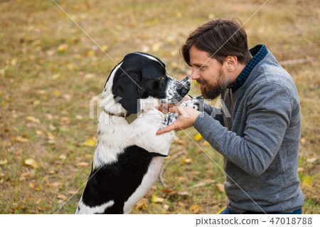 Man and dog in autumn park 47018788