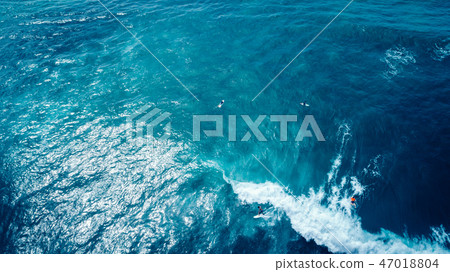Aerial view of surfe paddling for catching waves  47018804