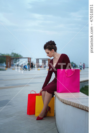 Girl holding shopping bags 47018851