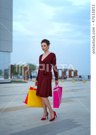 Girl holding shopping bags Girl holding shopping bags 47018853