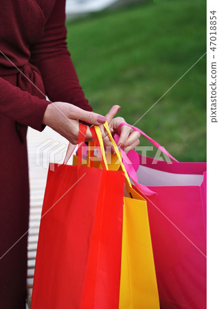 Girl holding shopping bags Girl holding shopping bags 47018854