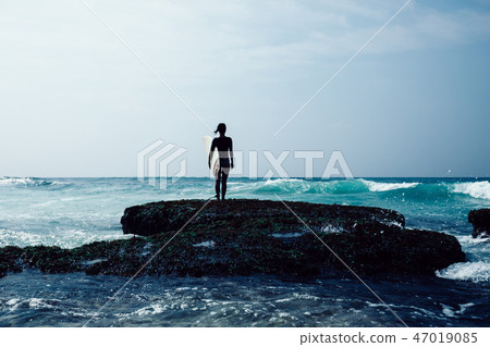 surfer with surfboard going to surf the big waves surfer with surfboard going to surf the big waves 47019085