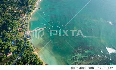 aerial view of coastline and fisherman village 47020536