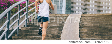woman runner sportswoman running up city stairs 47021589