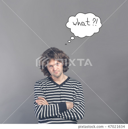 Skeptical man looking suspicious and questionable with drawn cloud of thoughts with what question in 47021634