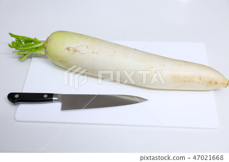 Cutting board with radish and kitchen knife Cutting board with radish and kitchen knife 47021668
