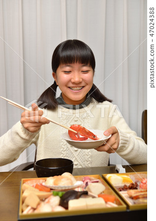 Girl eating New Year dishes (New Year) 47024388