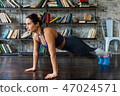 Woman doing push ups workout during fitness training on floor at home 47024571