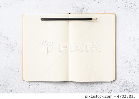 Top view of kraft paper notebook, page, pencil 47025833