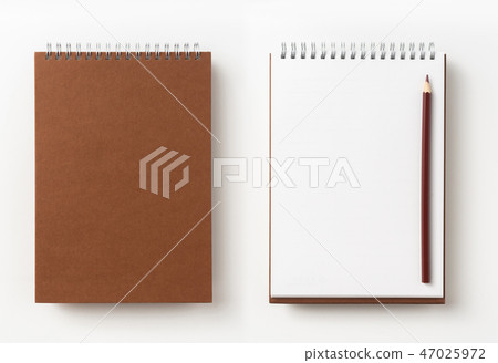 Top view of brown spiral notebook, page, pencil 47025972