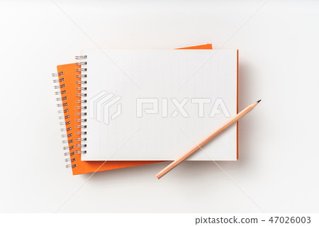 Top view of orange spiral notebook, page, pencil Top view of orange spiral notebook, page, pencil 47026003