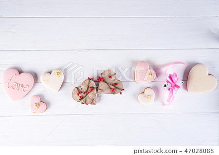 Sweets on Valentine's Day. Cookies in shape of heart and with lettering Love on dark wooden 47028088
