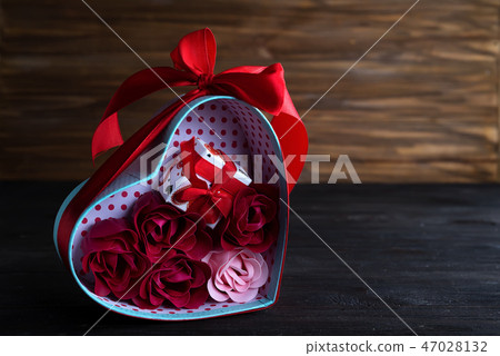 Valentines background with bouquet rose in gift box and mini gift box on dark wooden background 47028132