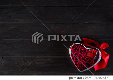 Valentines background with red hearts shaped and bouquet rose in gift box on dark wooden background 47028160