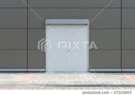 sidewalk by street wall & door sidewalk by street wall & door 47029065
