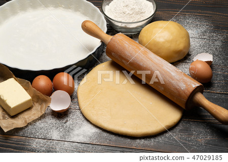 rolled and unbaked Shortcrust pastry dough recipe on wooden background 47029185