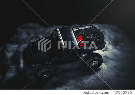 Radio-controlled car in the snow at night Radio-controlled car in the snow at night 47030750