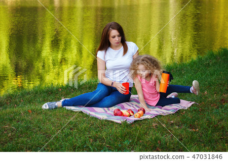 Family picnic. Mother and daughter Family picnic. Mother and daughter 47031846