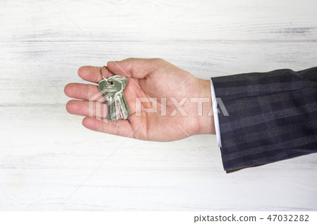 Keys in the businessman's hand. The concept Keys in the businessman's hand. The concept 47032282
