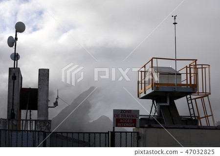 On the background of the mountains in the fog is a station for communicating 47032825