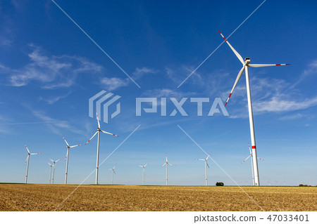 Windturbines in a yellow farmland landscape Windturbines in a yellow farmland landscape 47033401