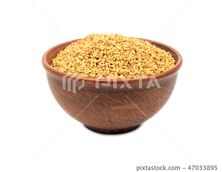 Grains of fenugreek in bowl Grains of fenugreek in bowl 47033895