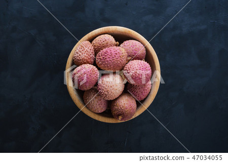 Ripe lychees on a black table. Top view. Ripe lychees on a black table. Top view. 47034055