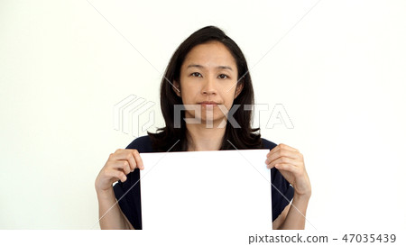 South East Asian girl holding while sign space South East Asian girl holding while sign space 47035439