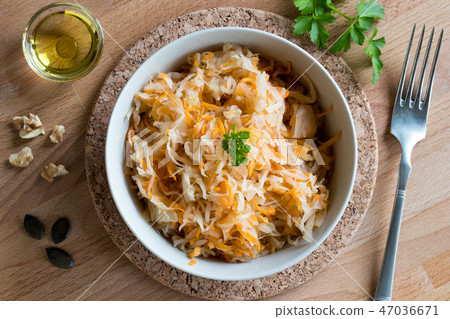 Fermented cabbage and carrots in a bowl, top view 47036671