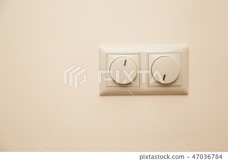 Electrical light dimmer switches on the wall Electrical light dimmer switches on the wall 47036784
