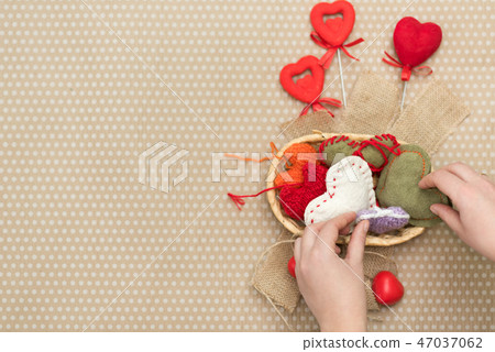 The child is holding red hearts on sticks The child is holding red hearts on sticks 47037062