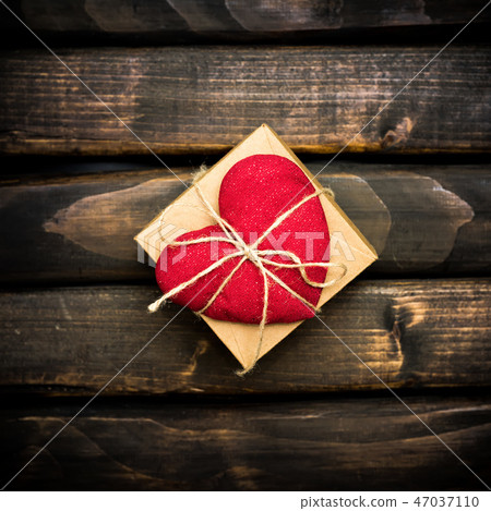 Red heart on a dark old boards Red heart on a dark old boards 47037110