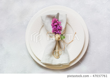 Easter table setting with lilac flowers on table.  47037761