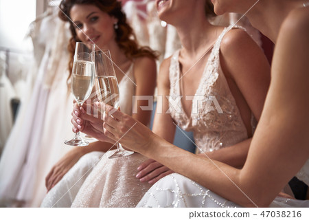 Close up of happy young brides with champagne Close up of happy young brides with champagne 47038216