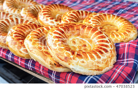 Baked traditional uzbek round flatbread Baked traditional uzbek round flatbread 47038523