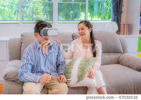Middle-aged couples, men trying to play VR glasses 47038536
