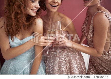 Close up of elegant ladies clanging champagne Close up of elegant ladies clanging champagne 47038586