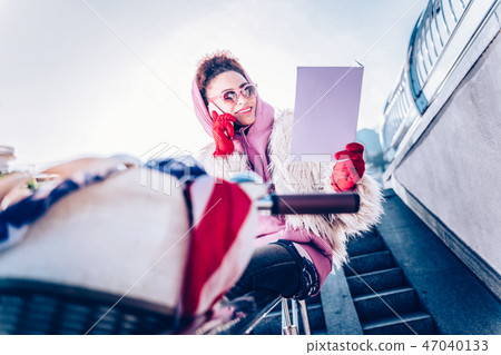 Positive delighted international girl checking her notes Positive delighted international girl checking her notes 47040133