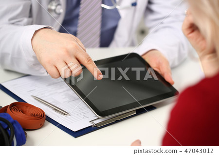 Female doctor hands hold and show digital 47043012