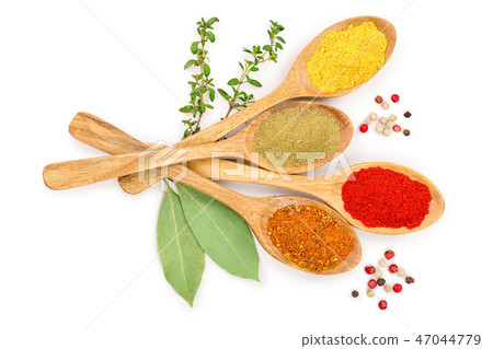 mix of spices in wooden spoon isolated on a white background. Top view. Flat lay. Set or collection 47044779