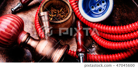 Smoking hookah with tobacco Smoking hookah with tobacco 47045600