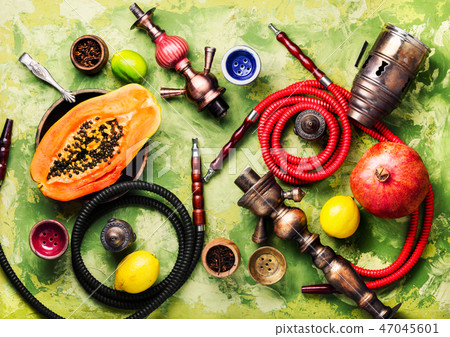 Smoking hookah with tobacco papaya Smoking hookah with tobacco papaya 47045601
