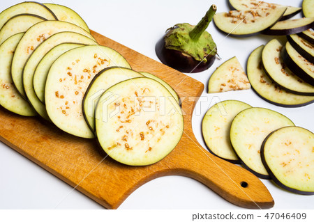 Sliced eggplant on a cutting board 47046409
