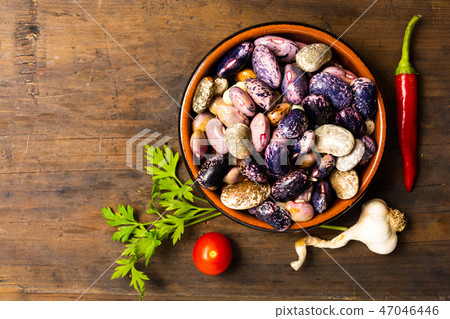 Natural beans in a bowl on a table 47046446