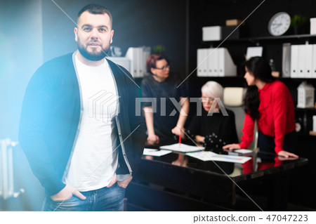 Young entrepreneur on background of Office workers discussing project Young entrepreneur on background of Office workers discussing project 47047223